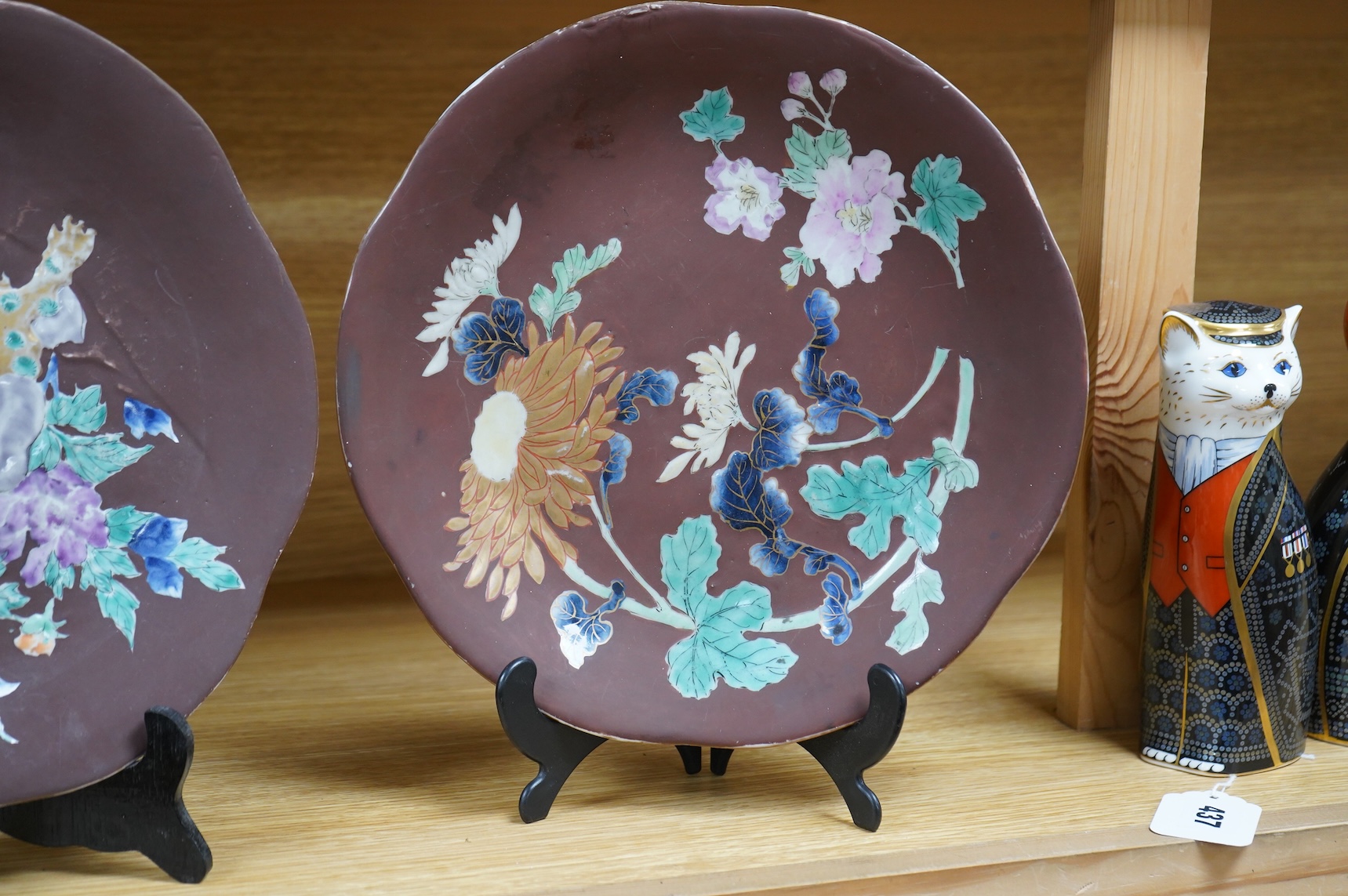 A pair of Japanese relief plates with brown glaze, 28cm high
